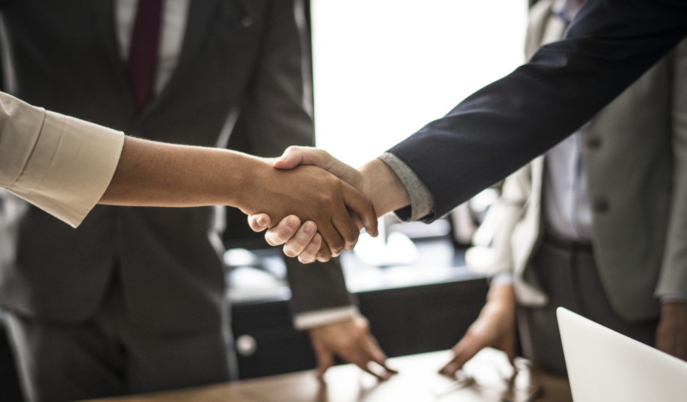 Handshake between formally dressed individuals